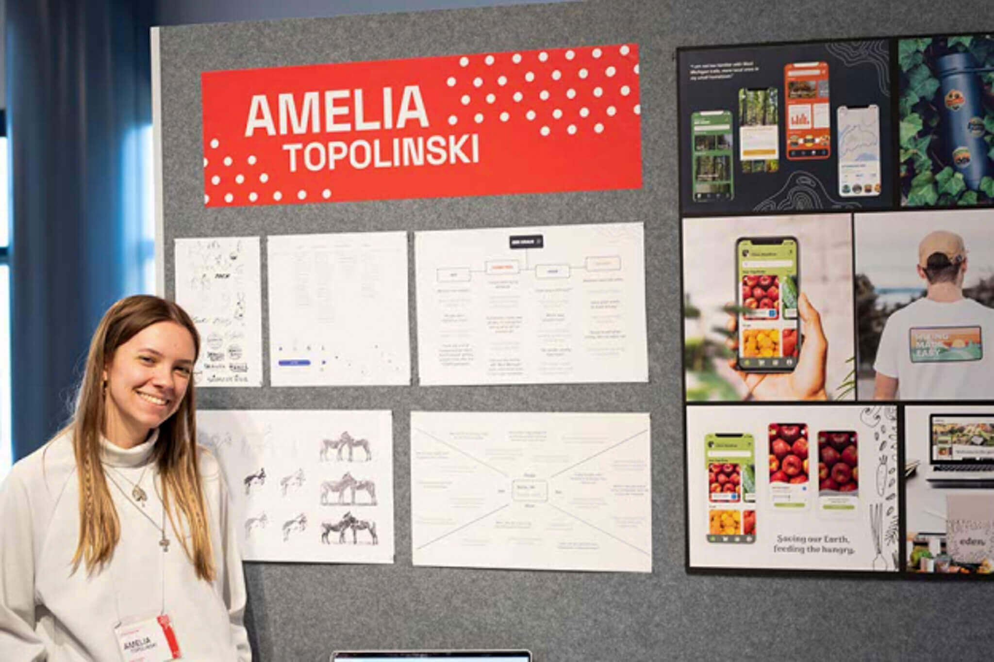 Senior Amelia Topolinski standing next to work displayed